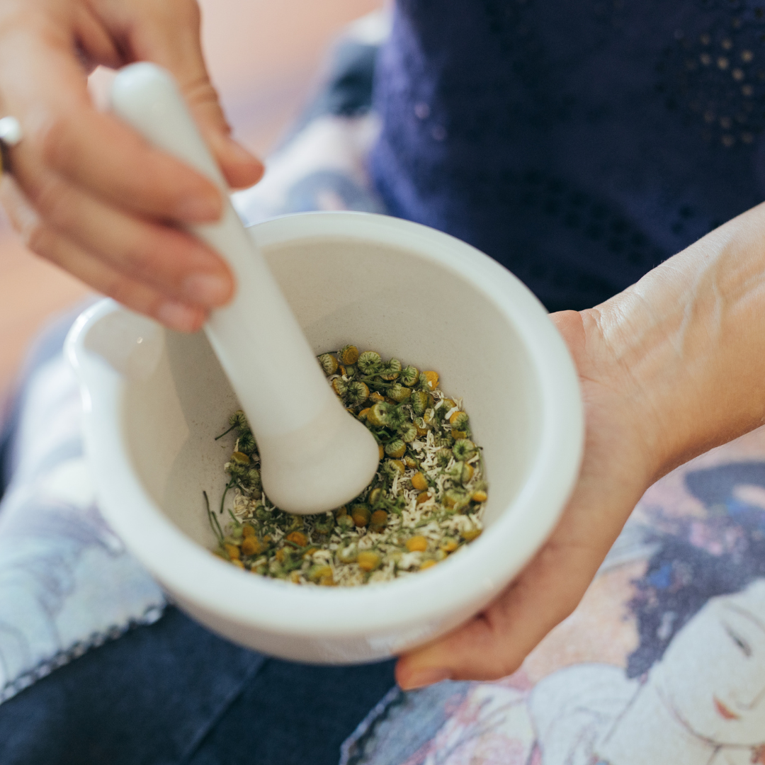 Mortar with chamomile and pestle